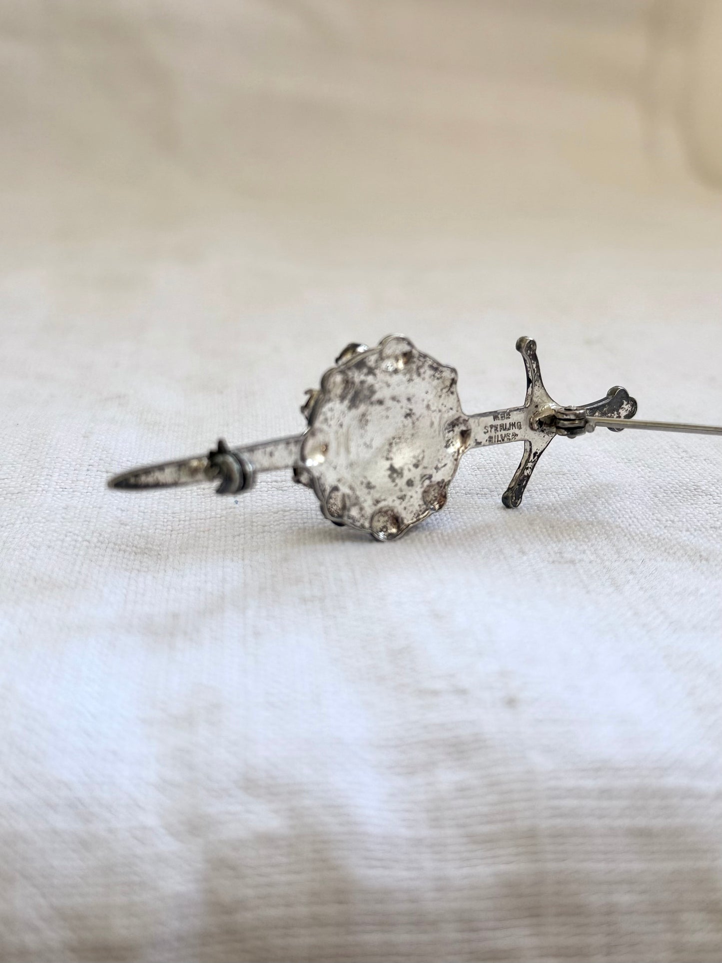 .1920s .1930s .925 Scottish silver Amethyst paste sword and shield brooch.