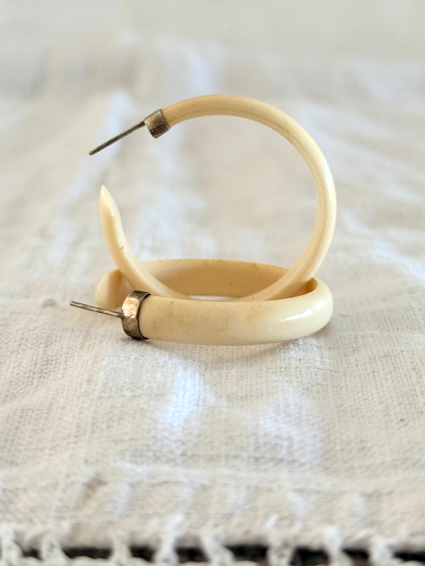 .1950s .1960s classic and gorgeous oversized pre ban Ivory hoop huggies capped in silver