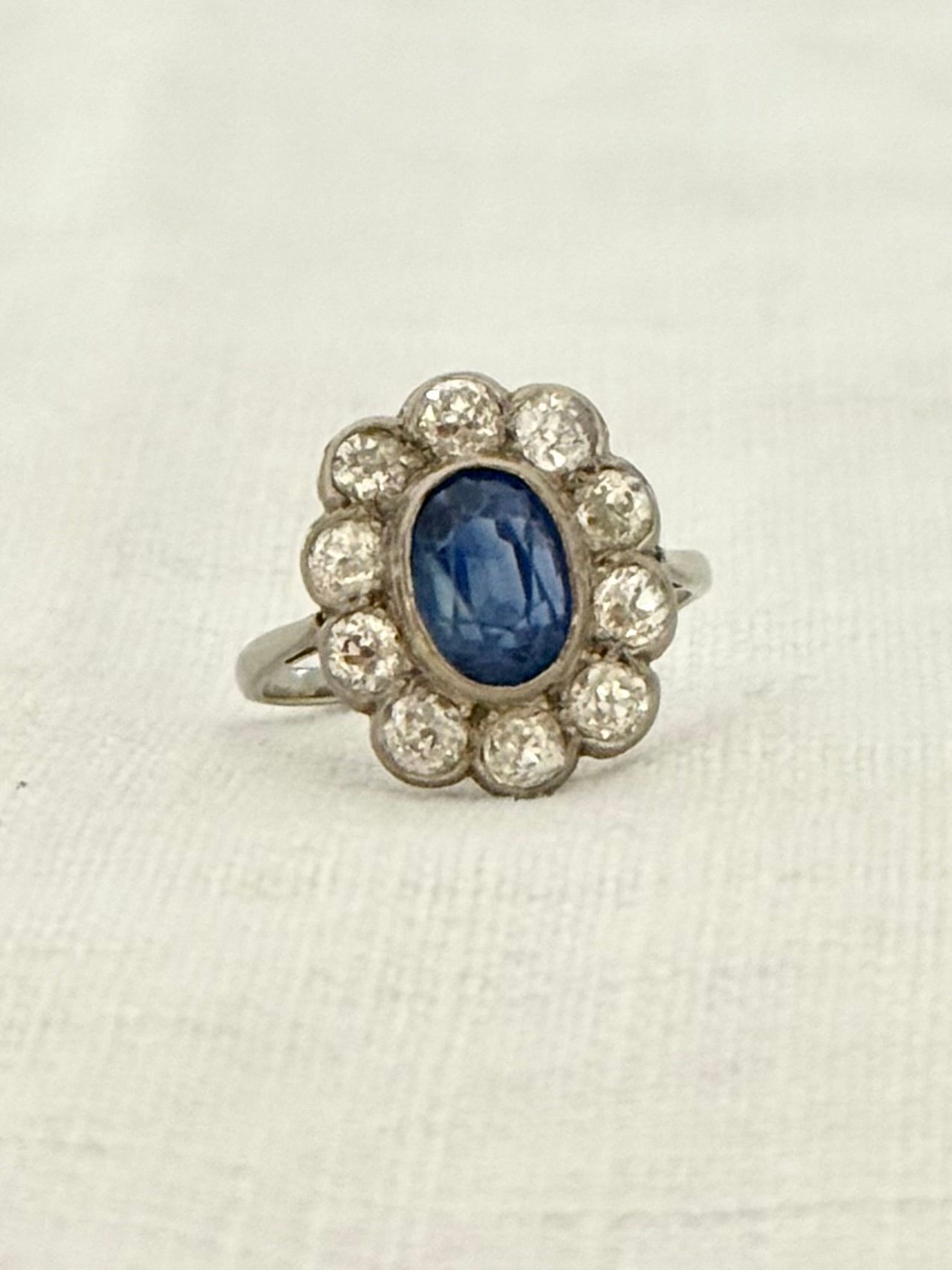 .18ct .1.20ct Old European cut diamonds and large 3.08ct Natural Sapphire era 1900s 1910s halo cluster white gold ring