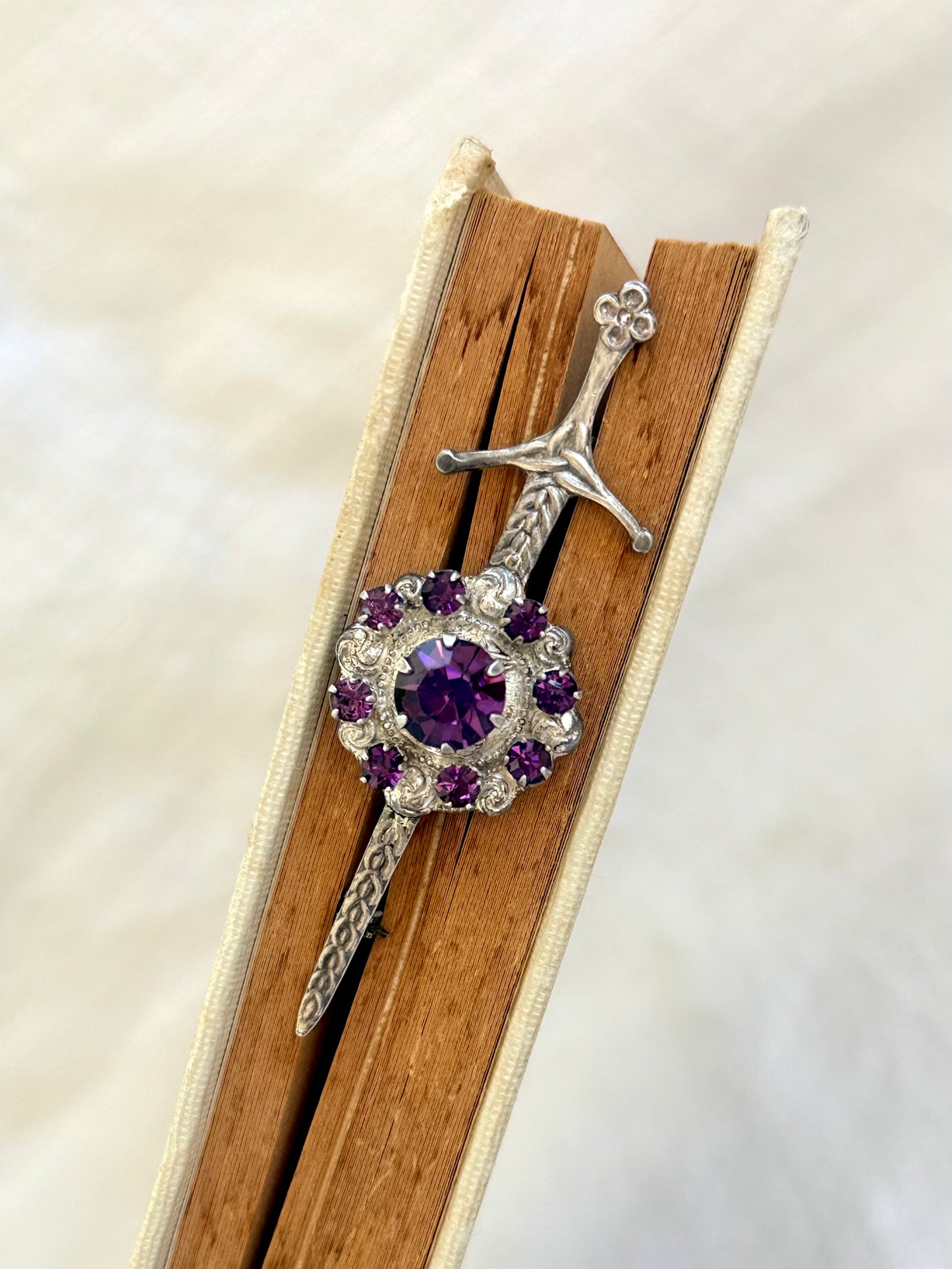 .1920s .1930s .925 Scottish silver Amethyst paste sword and shield brooch.