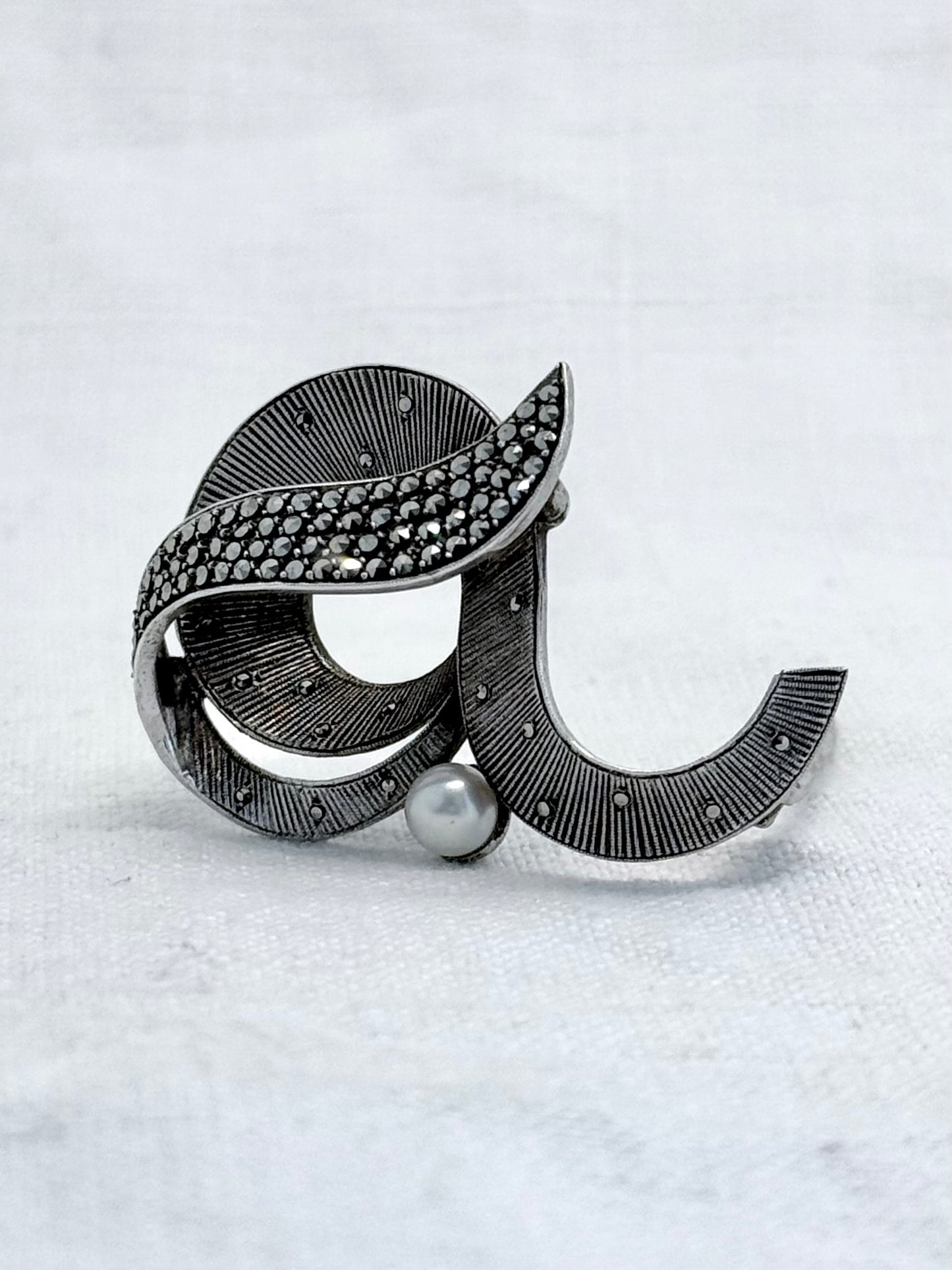 .1940s .1950s .925 silver Theodor Fahrner Mid Century Modern Art Deco revival renowned German Jurgendstill designer geometric swirl sterling silver, pearl and marcasite figural shape designer brooch pin