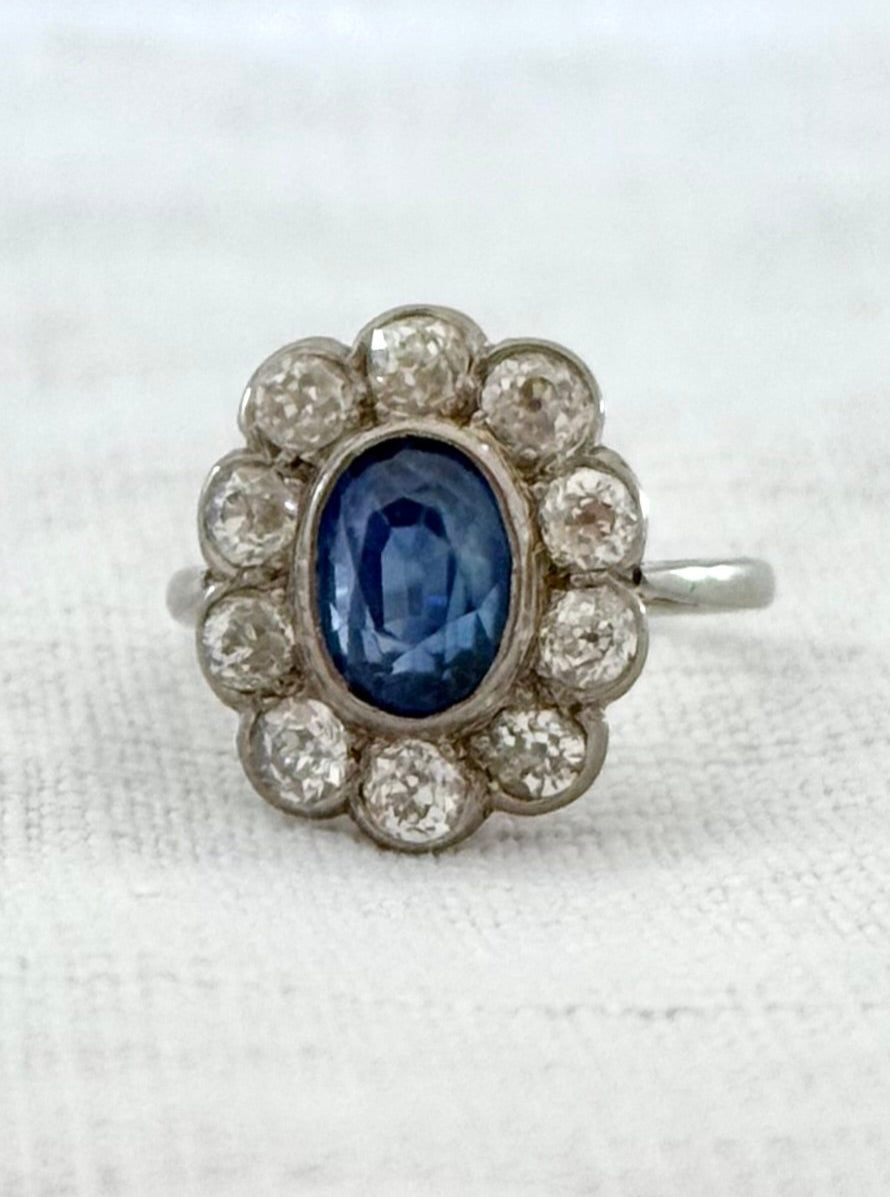 .18ct .1.20ct Old European cut diamonds and large 3.08ct Natural Sapphire era 1900s 1910s halo cluster white gold ring