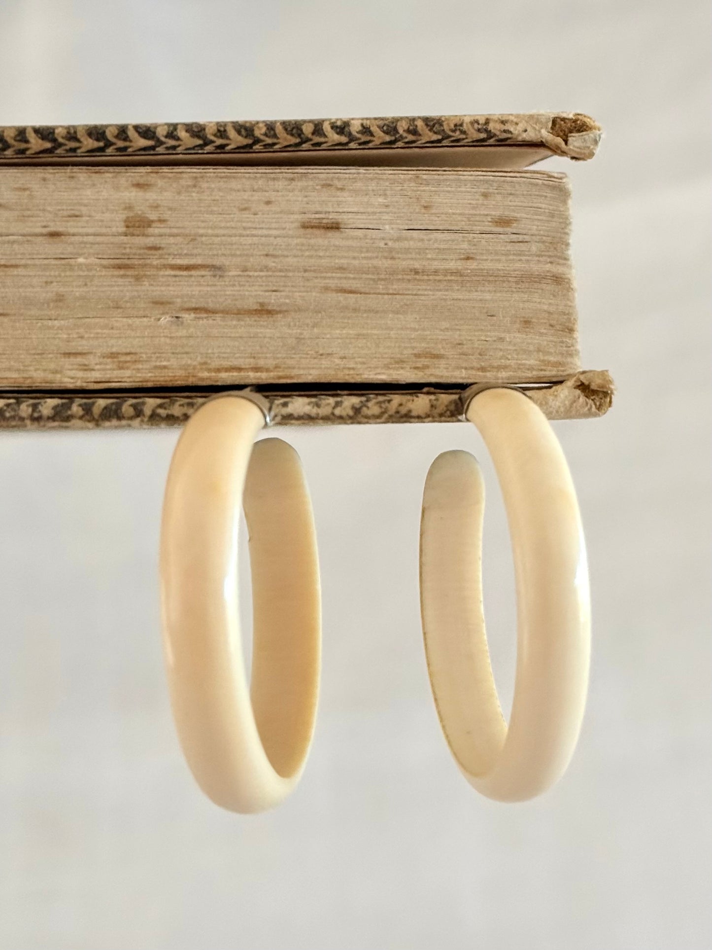 .1950s .1960s classic and gorgeous oversized pre ban Ivory hoop huggies capped in silver