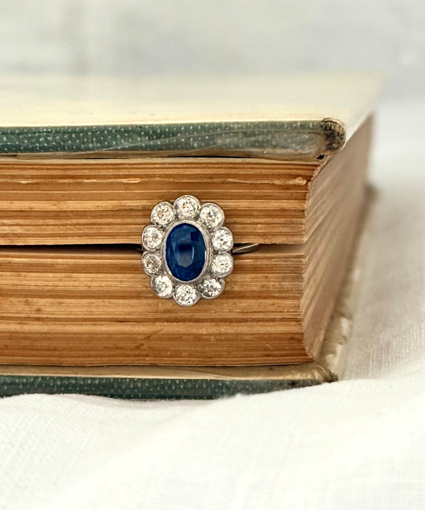 .18ct .1.20ct Old European cut diamonds and large 3.08ct Natural Sapphire era 1900s 1910s halo cluster white gold ring
