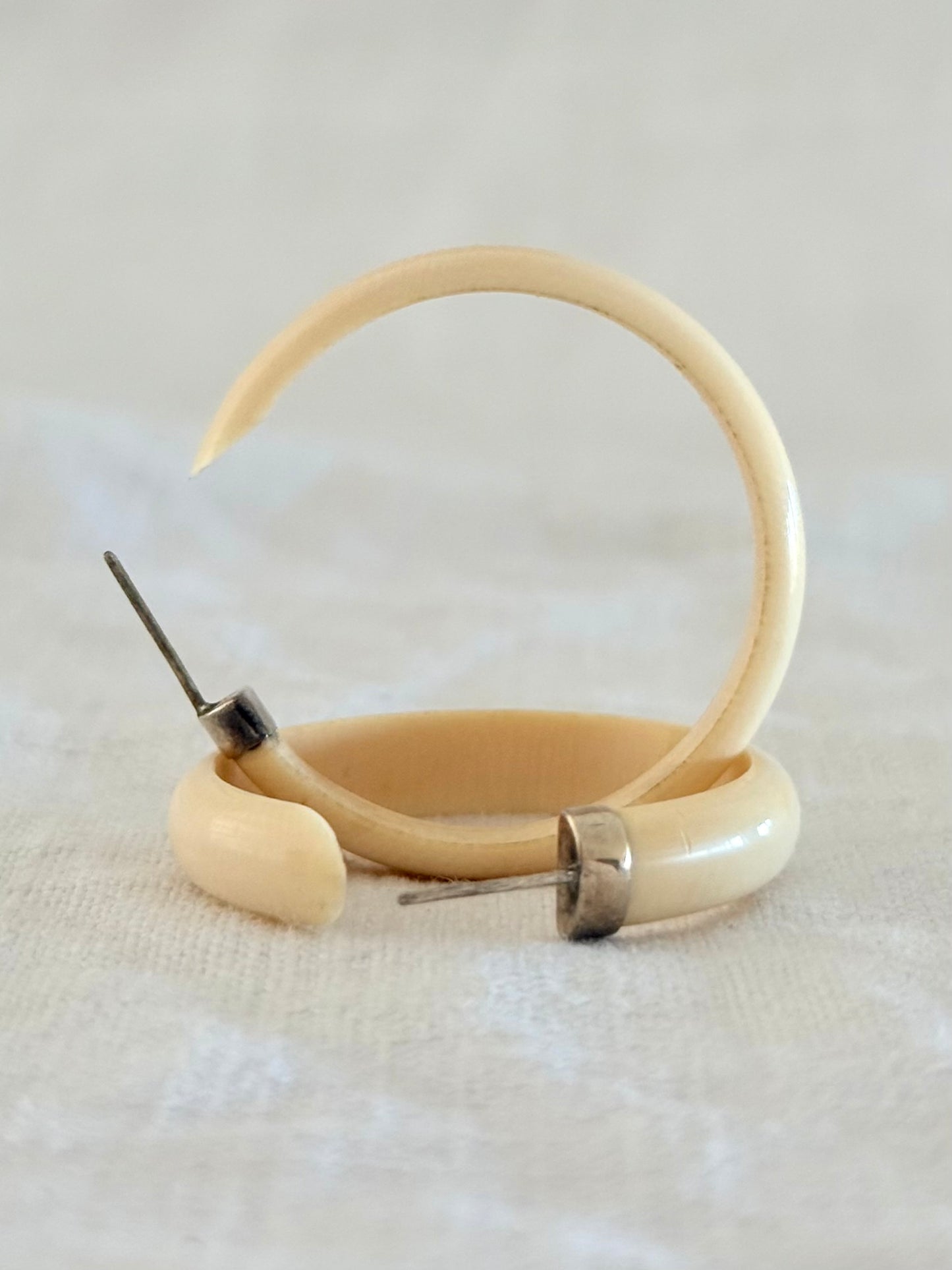 .1950s .1960s classic and gorgeous oversized pre ban Ivory hoop huggies capped in silver