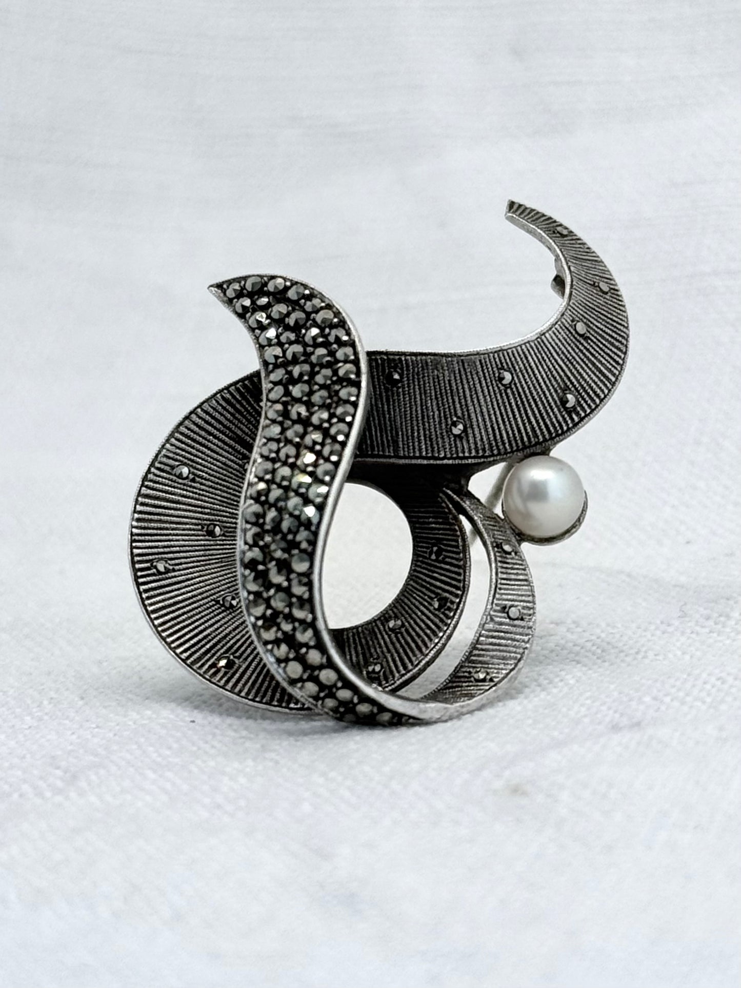 .1940s .1950s .925 silver Theodor Fahrner Mid Century Modern Art Deco revival renowned German Jurgendstill designer geometric swirl sterling silver, pearl and marcasite figural shape designer brooch pin