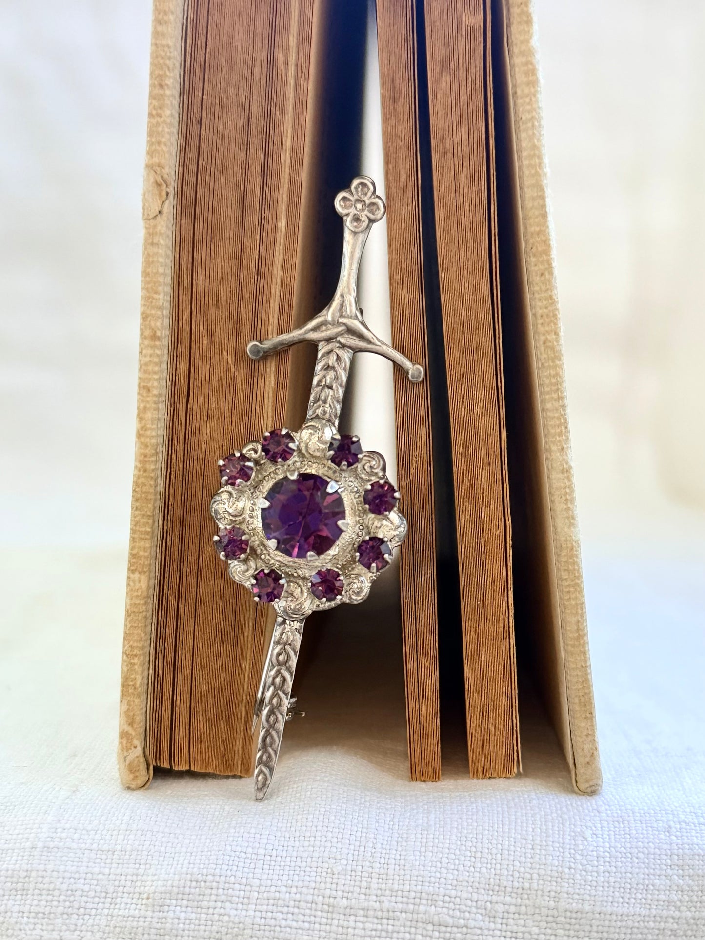 .1920s .1930s .925 Scottish silver Amethyst paste sword and shield brooch.