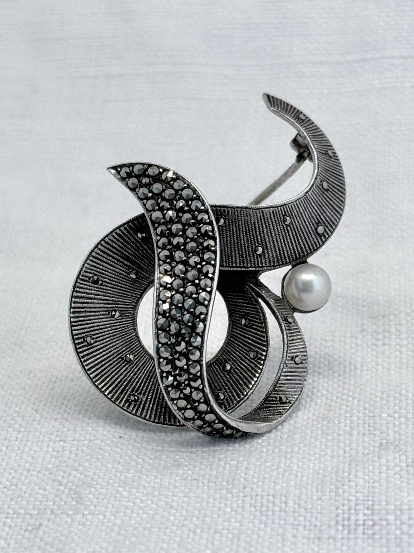 .1940s .1950s .925 silver Theodor Fahrner Mid Century Modern Art Deco revival renowned German Jurgendstill designer geometric swirl sterling silver, pearl and marcasite figural shape designer brooch pin