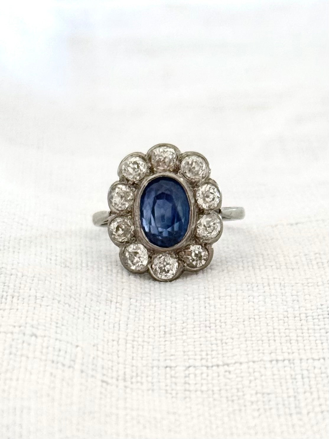 .18ct .1.20ct Old European cut diamonds and large 3.08ct Natural Sapphire era 1900s 1910s halo cluster white gold ring
