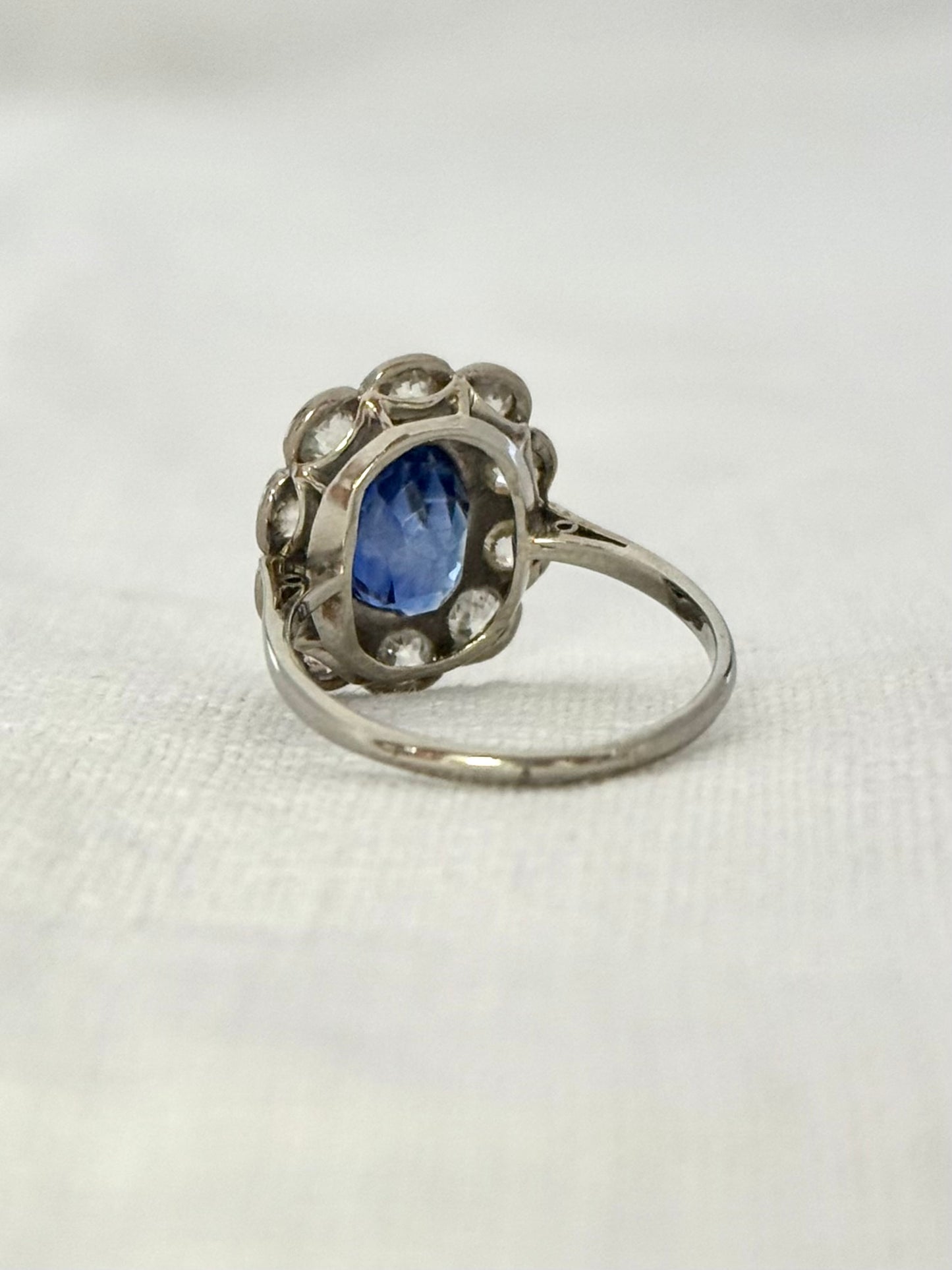 .18ct .1.20ct Old European cut diamonds and large 3.08ct Natural Sapphire era 1900s 1910s halo cluster white gold ring