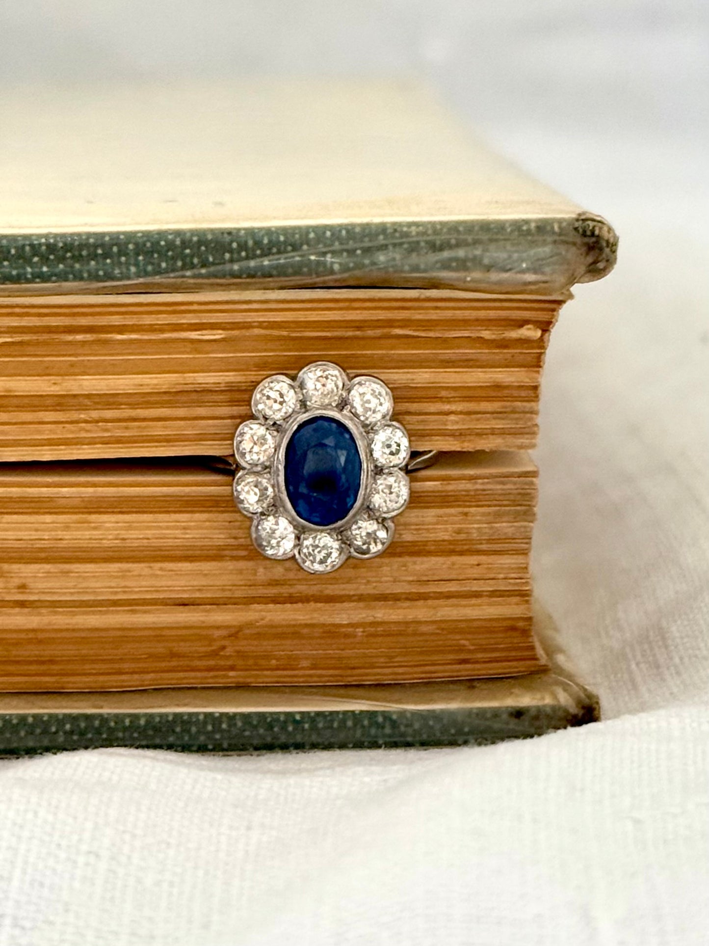 .18ct .1.20ct Old European cut diamonds and large 3.08ct Natural Sapphire era 1900s 1910s halo cluster white gold ring