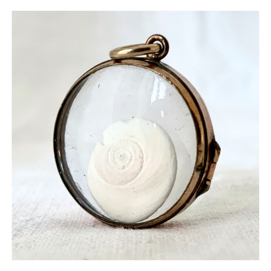 .1870s .1880s antique and very rare rock crystal Victorian solid rich gold pool of light style sought after antique orb circle memory locket.